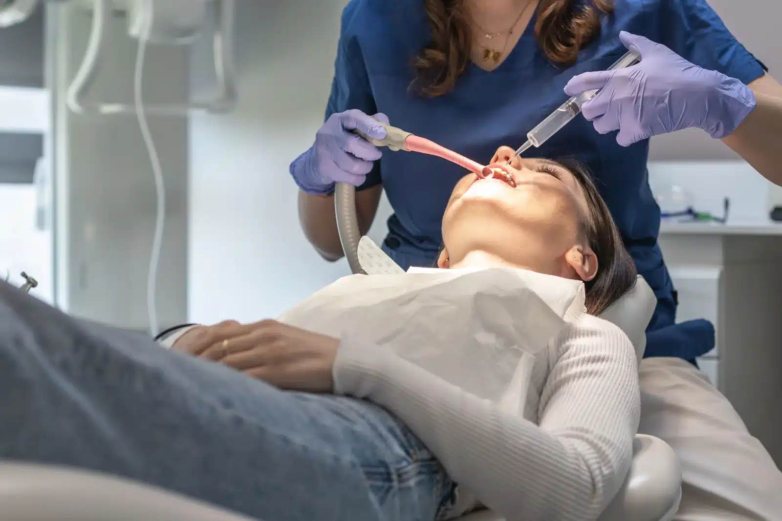 the dentist treats the broken or chipped tooth of the patient.