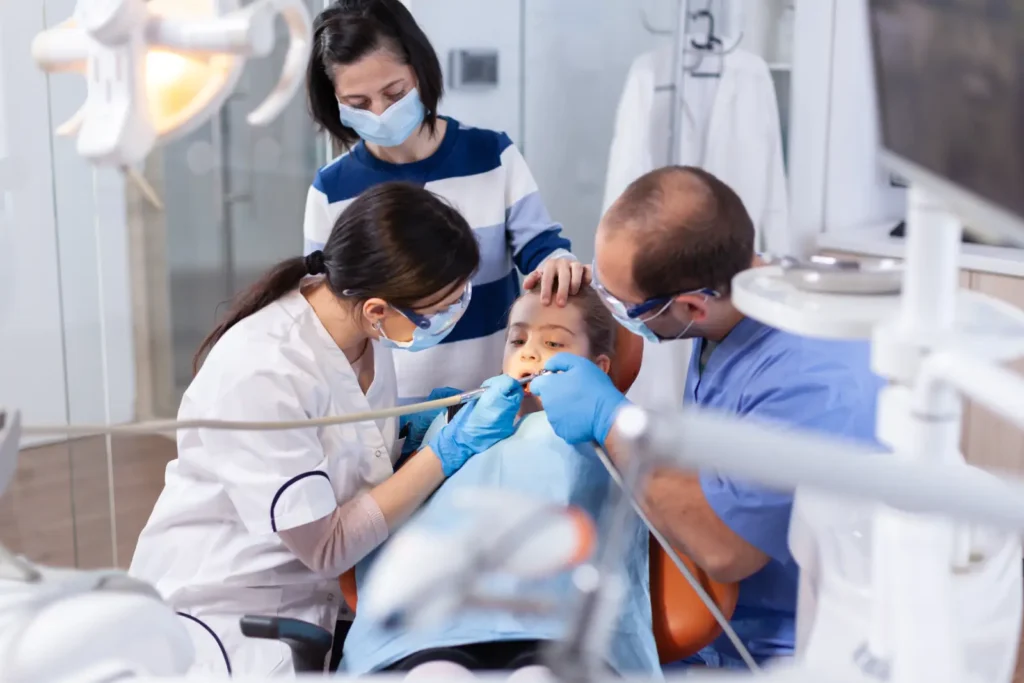 parent and emergency dentists in carina comforting a daughter during dental treatment
