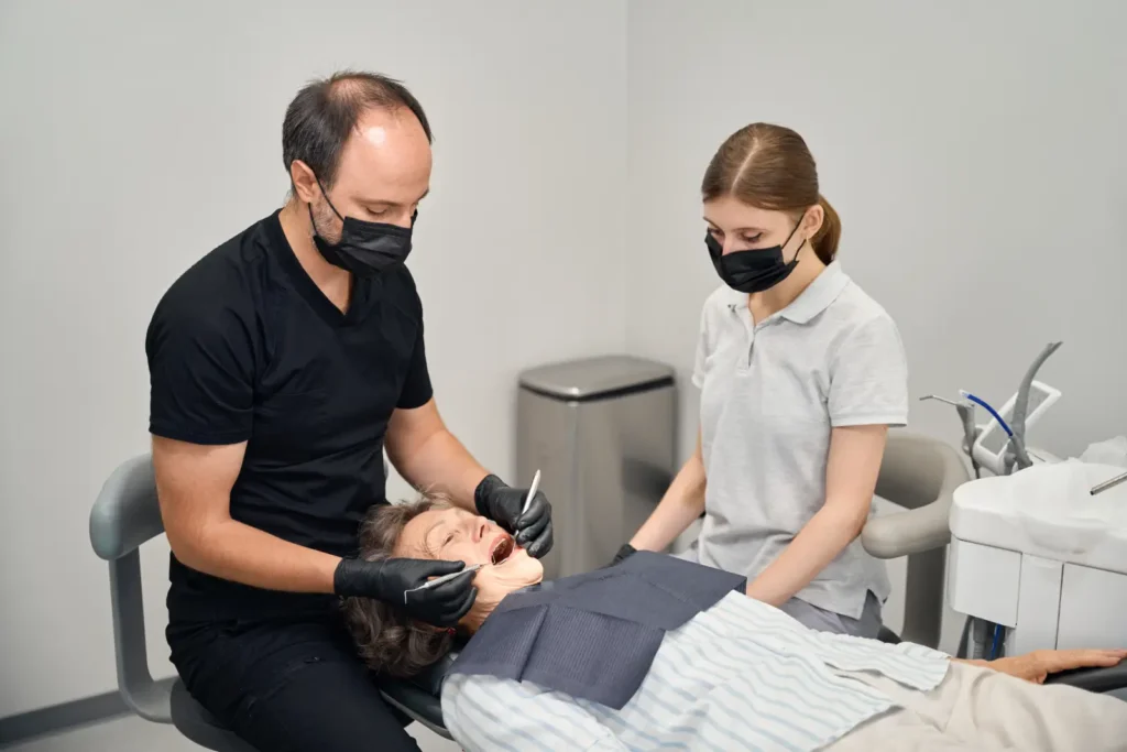 specialist treats elderly ladies teeth