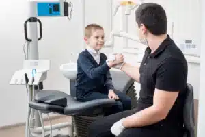 dentist shake hand with young kid