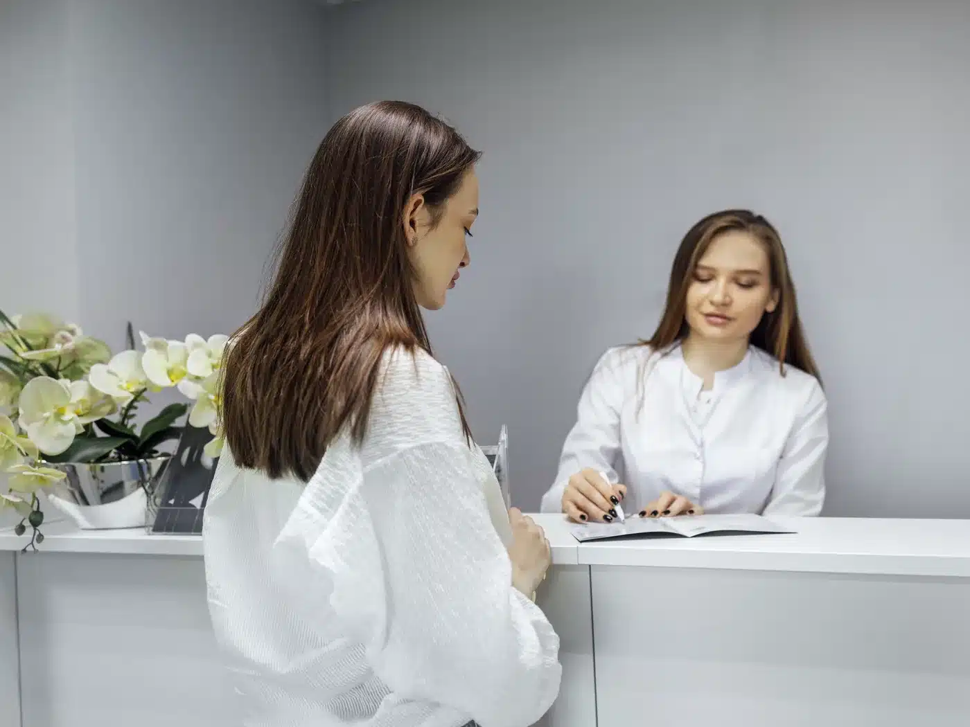 Patient at the Dental Nook reception desk claiming a health fund rebate