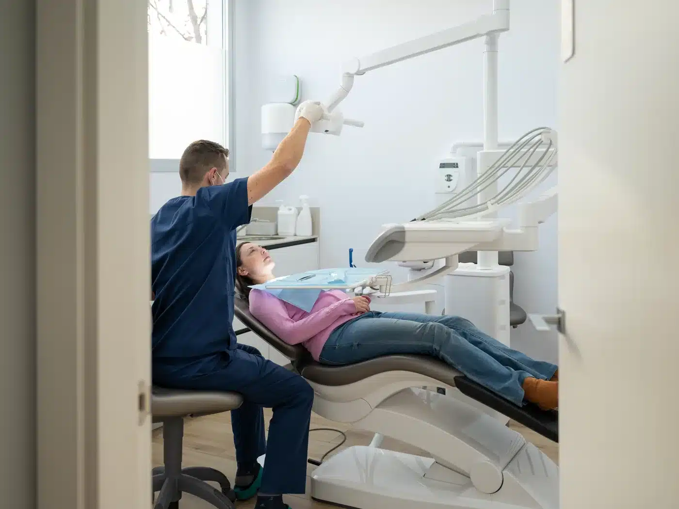 Dentist preparing a patient for treatment in a Brisbane dental surgery